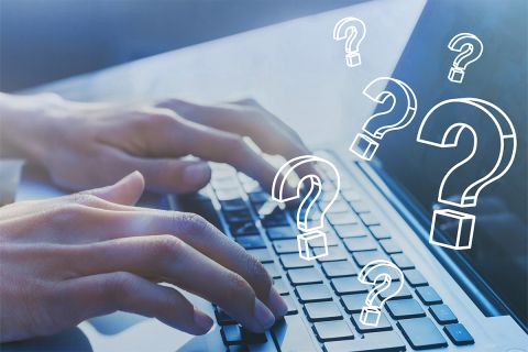 Photo of hands typing on a laptop with question marks over it. This illustrates the article Deception Detection: 3 Questions to Ask