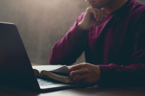 Photo of a person reading a Bible to illustrate the article 