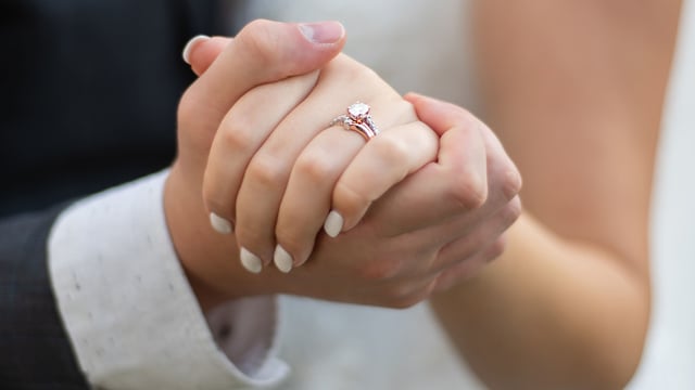 Photo of the hands of the couple at their wedding, to illustrate the article Lessons From 204 Years of Marriage.