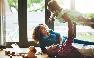 Photo of parents playing with child to illustrate the article The Family That Plays Together