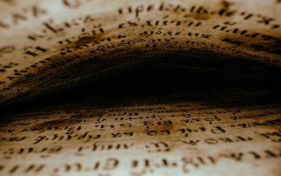 Graphic showing hard to read text above and below, as if between the pages of a book, fading to black in the center. This is to illustrate the article 